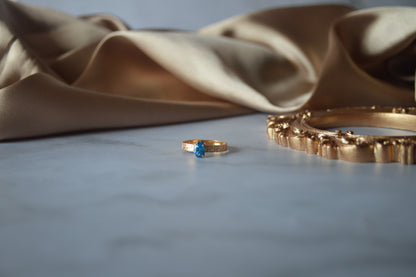 Original gold ring with light blue stone