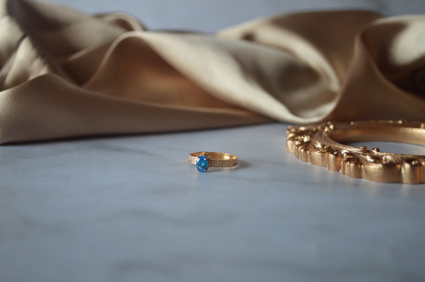 Original gold ring with light blue stone