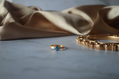 Original gold ring with light blue stone
